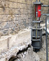A completed installation of foundation push piers lifting a foundation in Rockcliffe