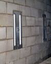 an inside view of foundation wall anchors installed along a basement wall to brace and repair the structure in Arnprior
