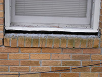 A window sill cracking and separating from the foundation wall in a Russell home.