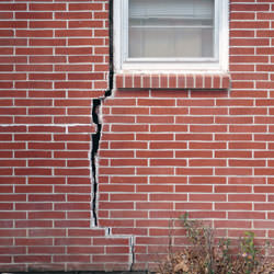 A foundation with a large crack that's wider at the top than on the bottom in Sarsfield