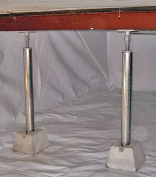 Crawl space jack posts installed in conjunction with a crawl space vapor barrier in Sarsfield