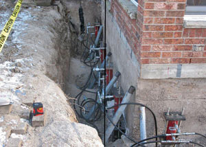 Foundation push piers installed around a house with a foundation settlement issues in Sarsfield