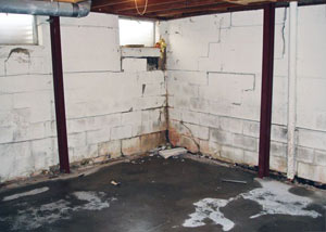 A failed, rusty i-beam foundation wall system installed in Sarsfield.