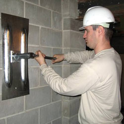 installing a wall anchor to repair an bowing foundation wall in Renfrew