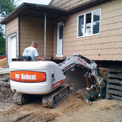 Excavating to expose the foundation walls and footings for a replacement job in Stittsville