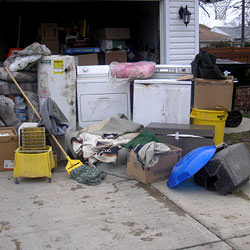 Soaked, wet personal items sitting in a driveway, including a washer and dryer in Smiths Falls.